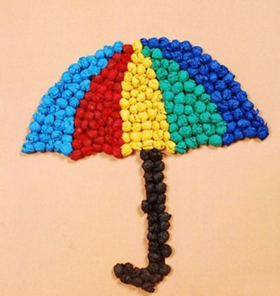 an umbrella made out of beads sitting on top of a pink surface with the letter j in it