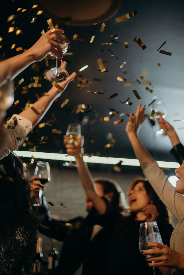 people are celebrating with confetti and champagne