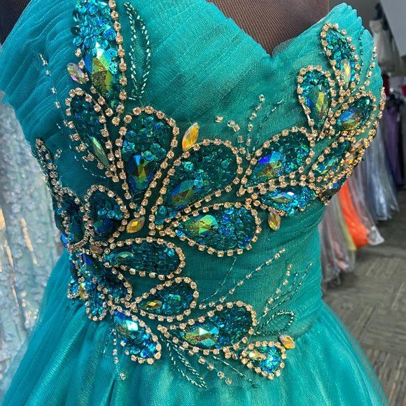 the back of a dress with blue and green sequins