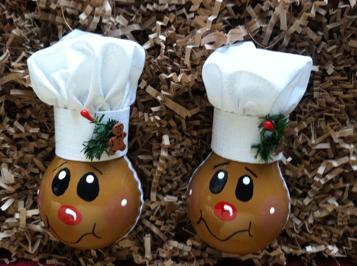 two decorated eggs in the shape of chefs hats on top of each other with pine needles sticking out of them