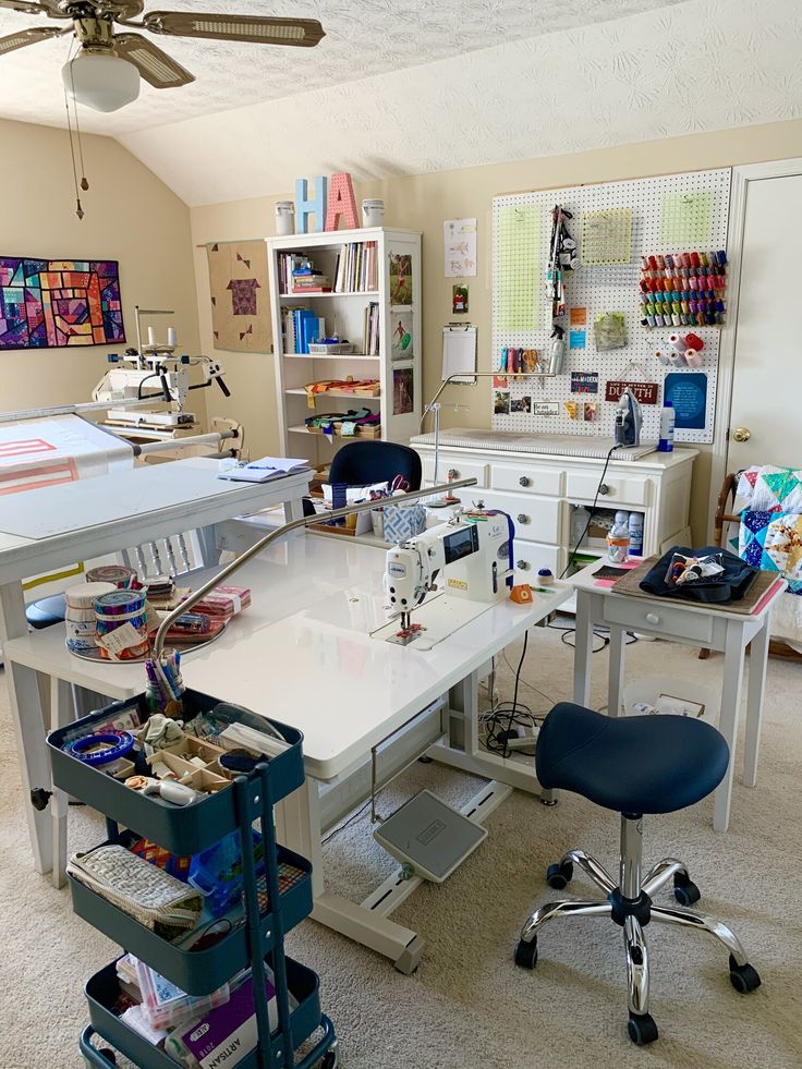 a sewing studio with many crafting supplies on the table