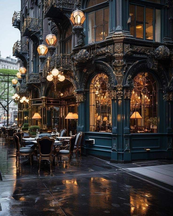 an outdoor restaurant with tables and chairs on a rainy day in the city at dusk