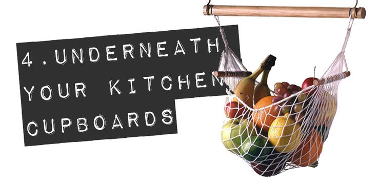 a hanging basket filled with fruit and vegetables next to a sign that says 4 undereath your kitchen cupboards