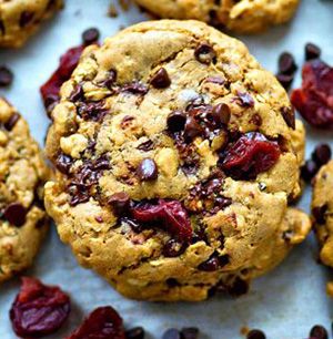 cookies with dried cranberries and raisins on a baking sheet