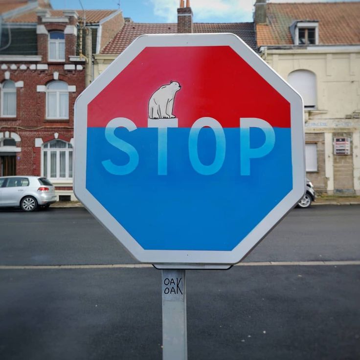 a stop sign with a polar bear painted on it