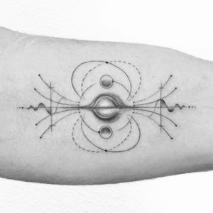 a black and white photo of a person's arm with an abstract tattoo on it