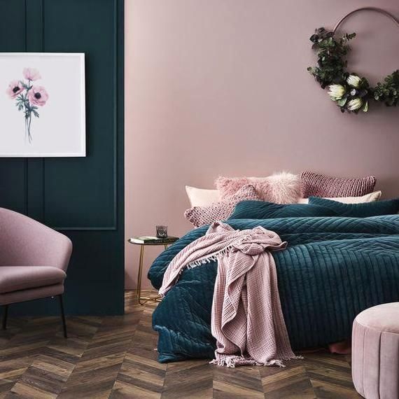 a bedroom with purple walls and green bedding