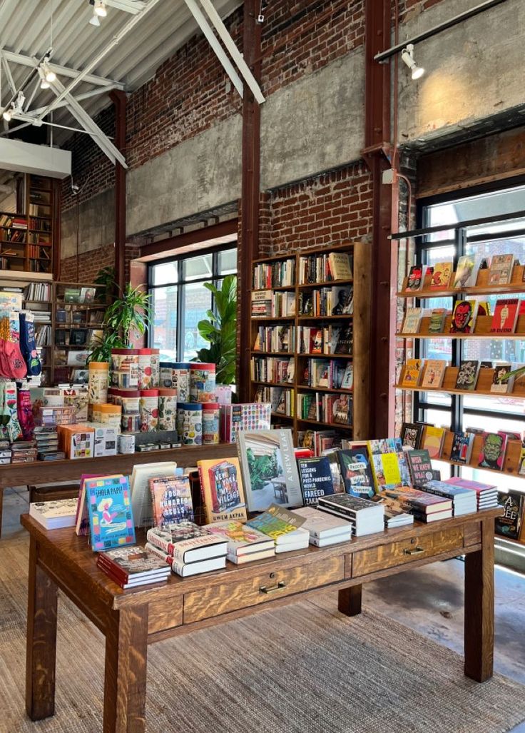 the inside of a book store with many books on tables and shelves full of books