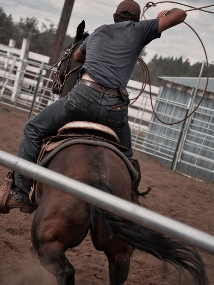 a man riding on the back of a brown horse