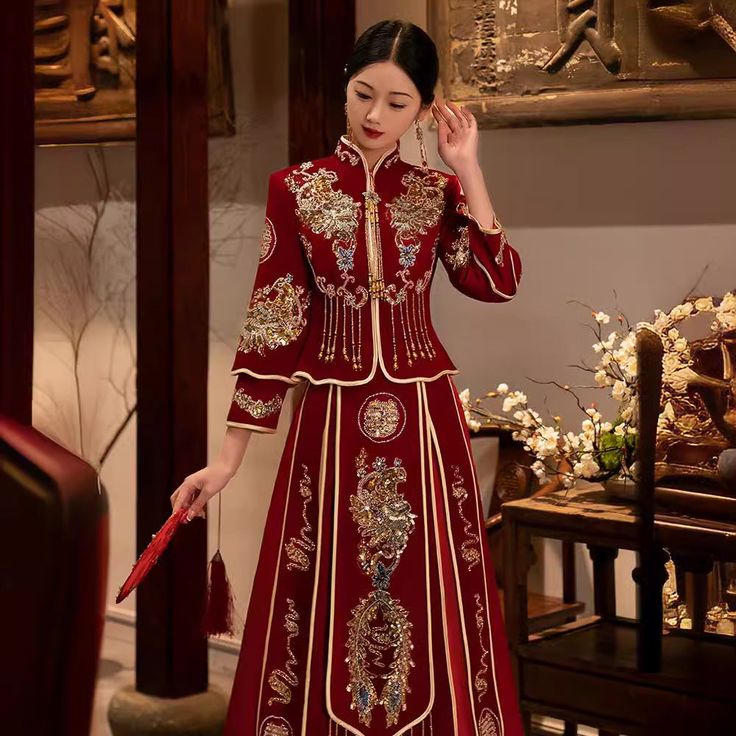 a woman in a red and gold chinese dress