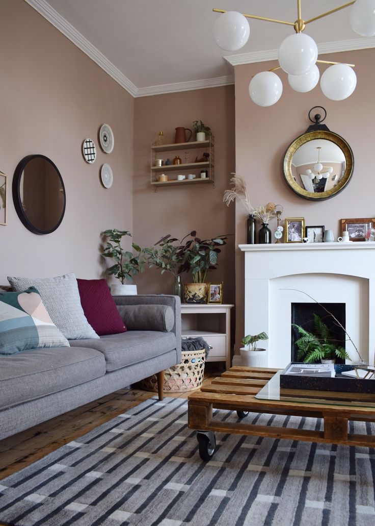 a living room filled with furniture and a fire place in front of a white fireplace