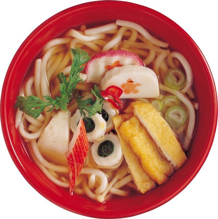 a red bowl filled with noodles, vegetables and meats on top of each other