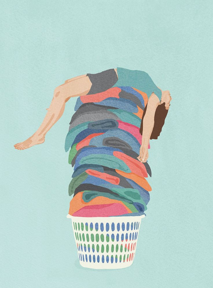 a person laying on top of a pile of clothes in a laundry basket with his head down