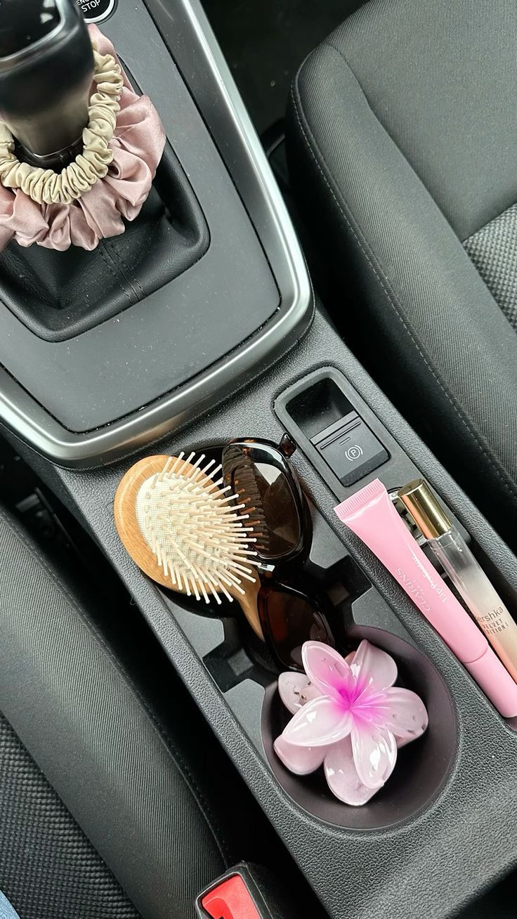 the interior of a car with various items in its holder and on it's console