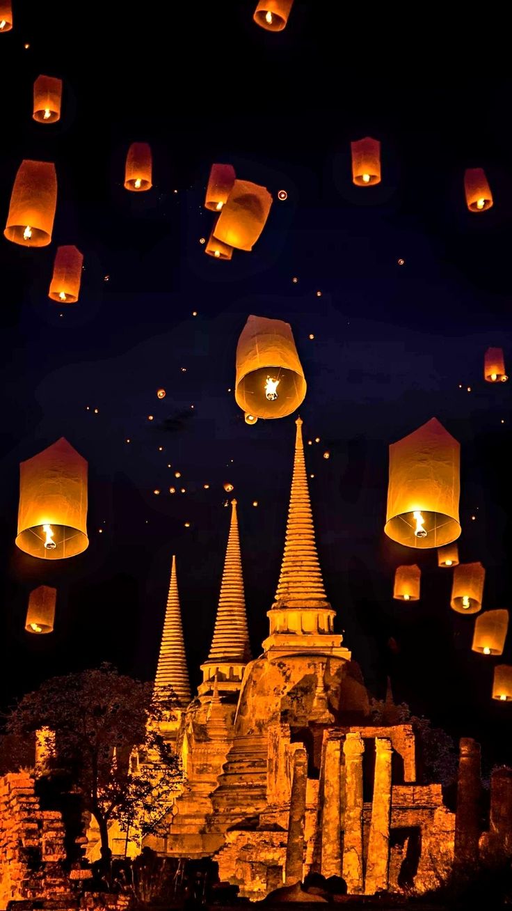 many paper lanterns floating in the air