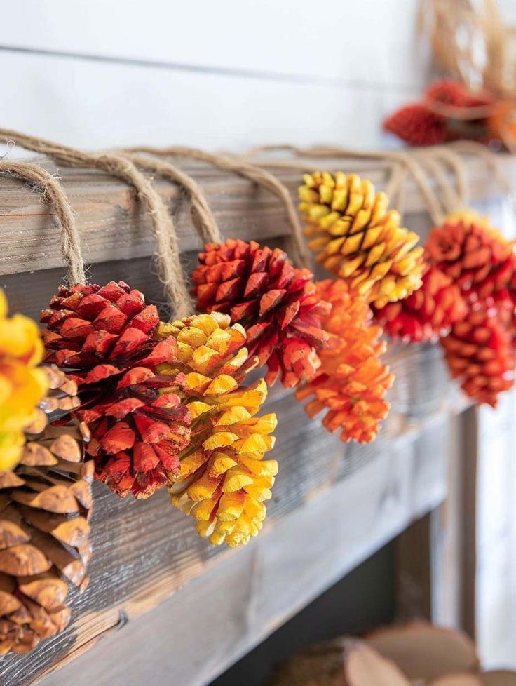 pine cones are hung on a string with twine to hang from the mantel