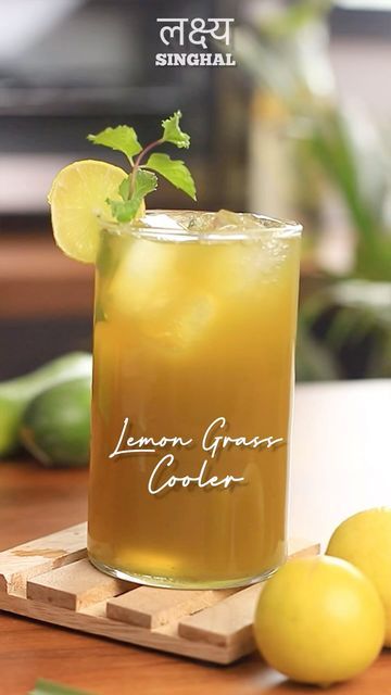 a lemon green cooler sitting on top of a wooden cutting board next to limes