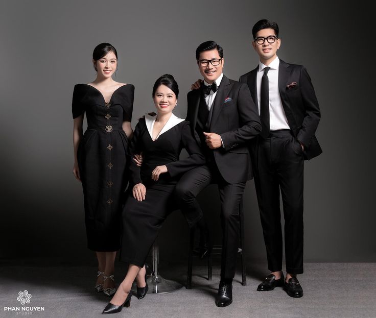 three people in formal wear posing for a photo with one woman and the other man