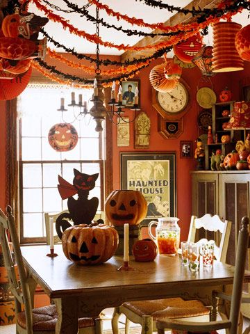 a dining room decorated for halloween with pumpkins and decorations