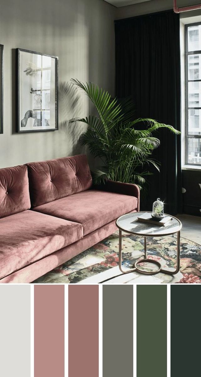 a living room with pink couches and green plants in the corner, along with black curtains