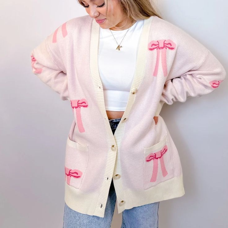 Stay Cozy And Chic With Our Oversized Bow Cardigan. Crafted From Soft, Luxurious Knit Fabric, This Cardigan Features An Effortlessly Elegant Bow Design Throughout , Adding A Touch Of Femininity To Your Look. With Its Relaxed Fit And Versatile Style, It's Perfect For Layering Over Your Favorite Tops For A Polished Yet Comfortable Ensemble. Whether You're Lounging At Home Or Stepping Out For A Casual Outing, This Cardigan Is Sure To Keep You Stylishly Snug All Day Long. Features - Front Buttons - Pink V-neck Cardigan For Loungewear, Pink Oversized V-neck Sweater, Oversized Pink V-neck Sweater, Cozy Pink V-neck Outerwear, Trendy Pink V-neck Outerwear, Oversized Trendy Pink Cardigan, Chic Oversized Pink Cardigan, Oversized Chic Pink Cardigan, Feminine Sweater For Winter Day Out