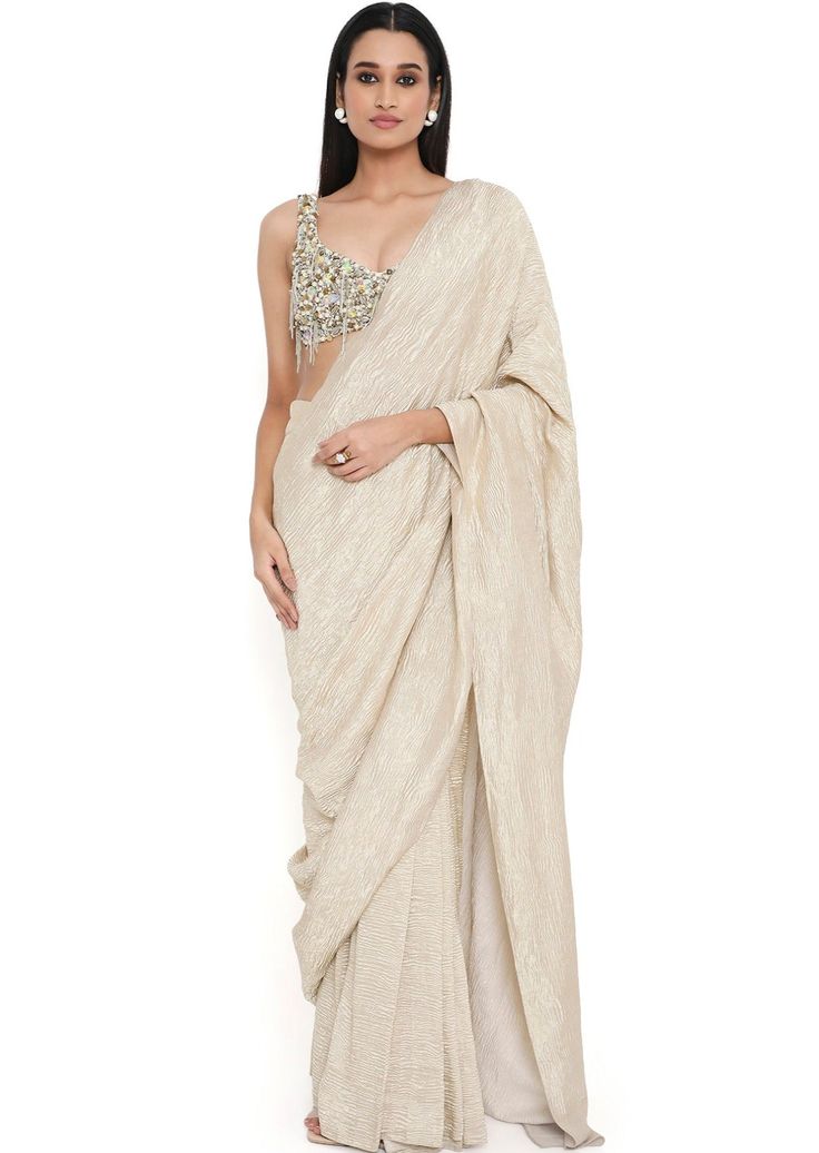 Off white georgette embroidered choli with tissue saree. Disclaimer: Since we are a made-to-measure brand and our dyeing process and embroidery are handcrafted, there may be slight variations in the color and embroidery of the actual product. The print placement may also vary from what is represented in the images shown on the product page. Reception Chikankari Embroidery Pre-draped Saree In Cotton Silk, Cotton Silk Pre-draped Saree With Chikankari For Reception, Off White Traditional Drape Blouse Piece For Reception, Off White Blouse Piece For Reception With Traditional Drape, Pre-draped Saree With Chikankari Embroidery For Transitional Reception, Pre-draped Saree With Chikankari Embroidery For Reception, Off White Resham Embroidered Pre-draped Saree For Diwali, Off White Pre-draped Saree With Cutdana, Off White Pre-draped Saree With Resham Embroidery For Diwali