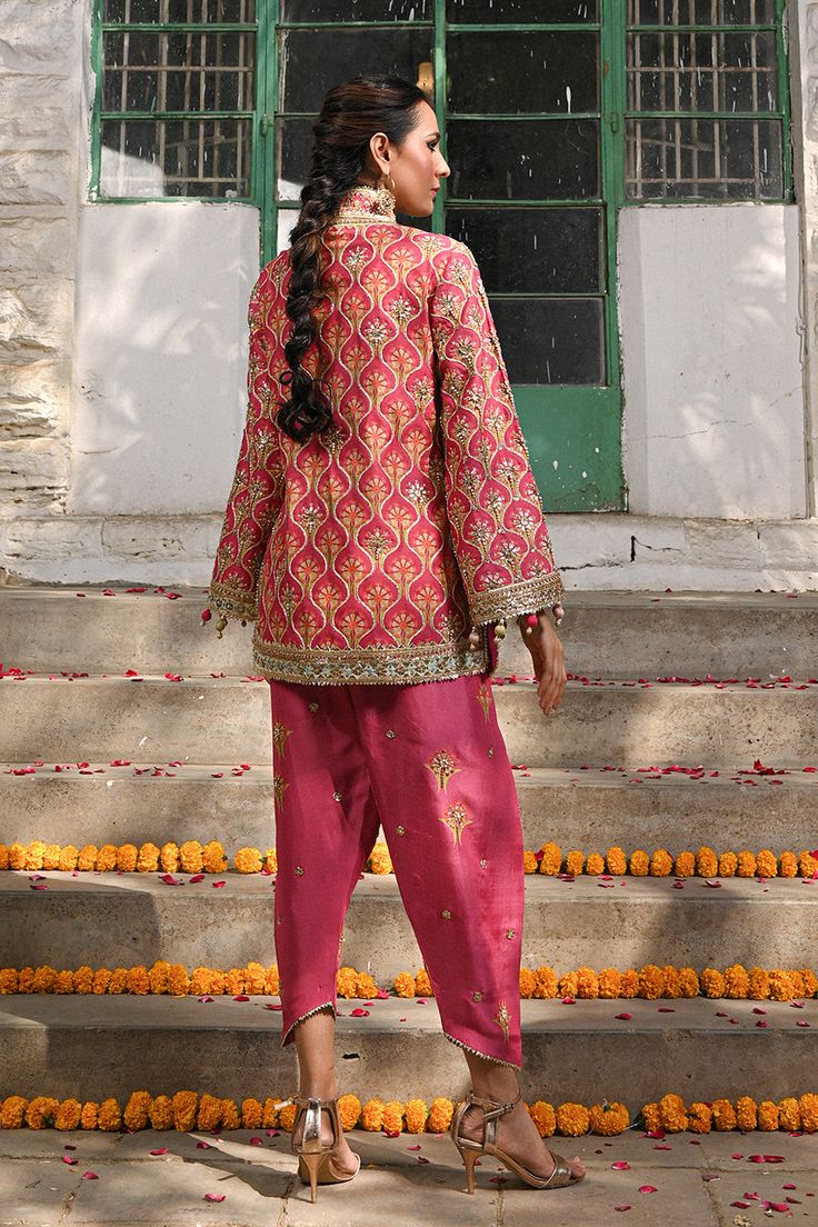 A fresh spin on a classic silhouette - a coral printed khaddi silk jacket with gota and zardoze work and colourful tassel details. The look is completed with a coral raw silk shalwar embellished with embroidered floral motifs. Bridal Suits Punjabi, Bridal Suits, Suits Punjabi, Coral Print, Website Features, Boutique Dress Designs, Boutique Dress, Silk Jacket, Indian Designer