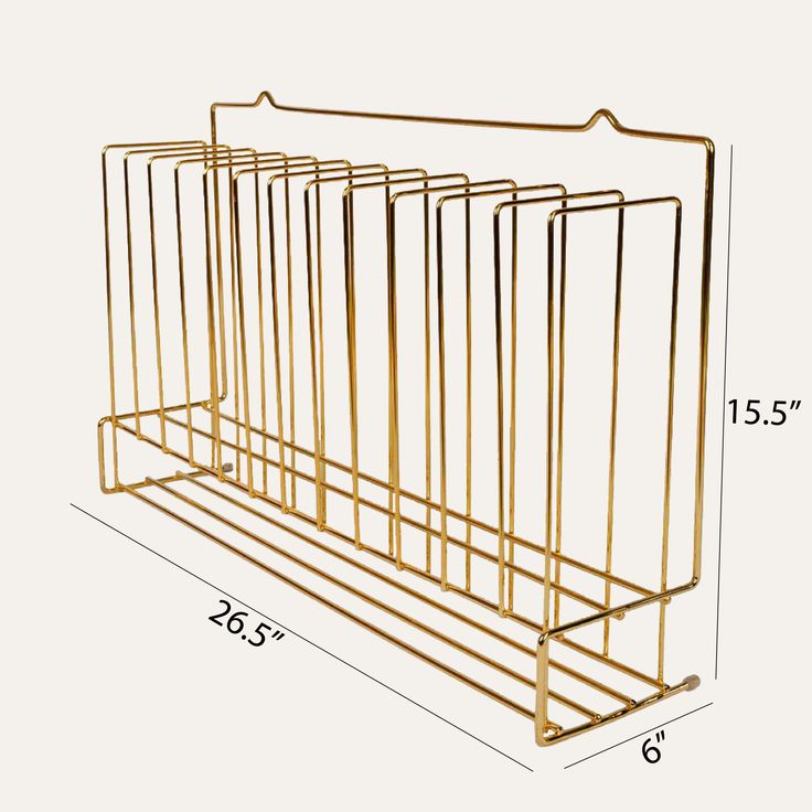 the gold metal magazine rack is shown with measurements for each section, and it has five sections