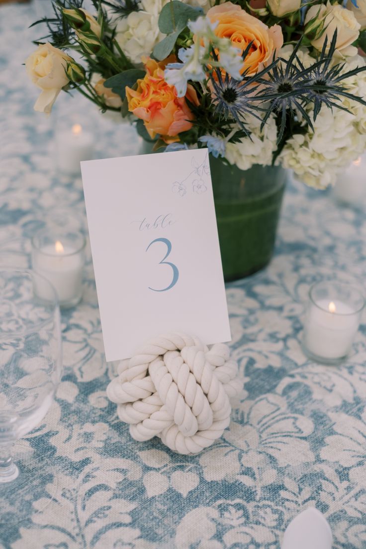 a table with flowers and candles on it