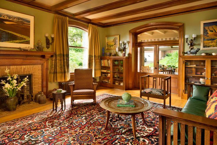 a living room filled with furniture and a fire place in the middle of a room