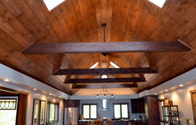 a large open living room with wooden ceilings