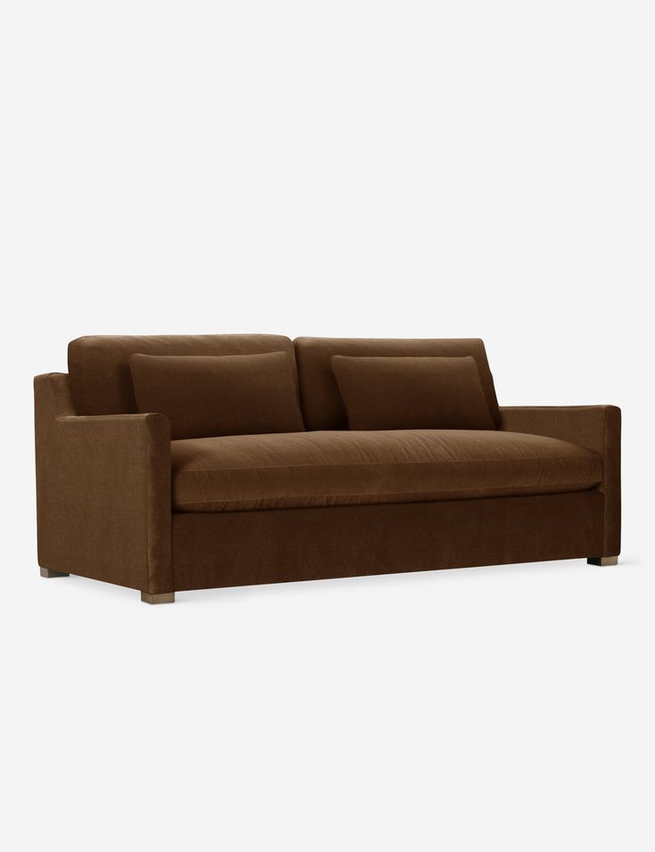 a brown couch sitting on top of a white floor