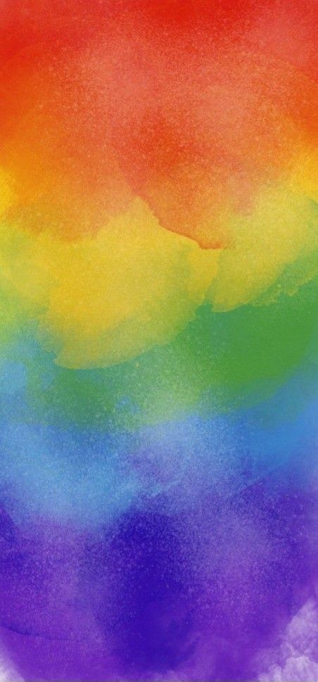 a rainbow colored background with watercolor stains