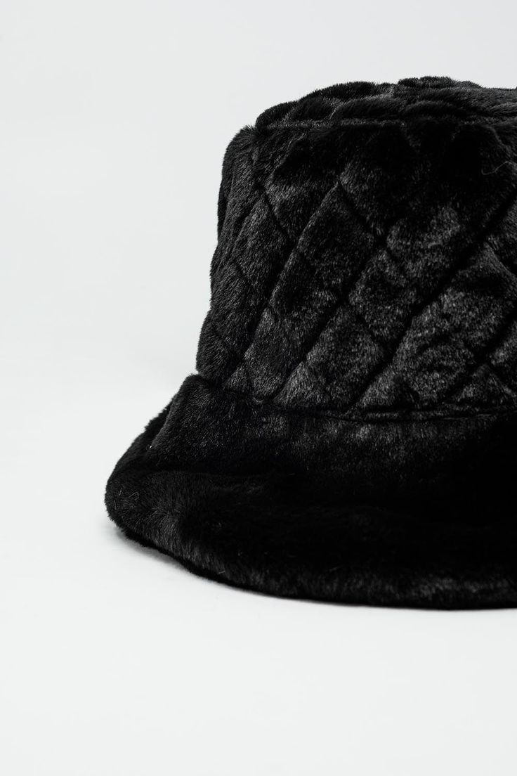 Elevate your winter wardrobe with our Quilted Bucket Hat in Black Faux Fur. Luxuriously crafted with plush faux fur and adorned with exquisite quilted details, this hat effortlessly blends comfort with style. The timeless allure of the bucket hat meets the cozy warmth of faux fur, ensuring you stay fashion-forward while staying snug in colder temperatures.  Made from 100% polyester, this hat is as durable as it is chic. The one-size-fits-all design adds versatility to your accessory collection, making it a perfect addition to any ensemble. Whether you're heading to a festive party or simply strolling through the winter wonderland, this hat is your go-to accessory for a touch of glamour.  Embrace the playful charm of the fluffy knit texture, adding a whimsical flair to your outfits. Pair it Fluffy Hat, Fluffy Knit, Style Party, Black Faux Fur, Winter Wear, Winter Wardrobe, Bucket Hat, Fashion Forward, Faux Fur