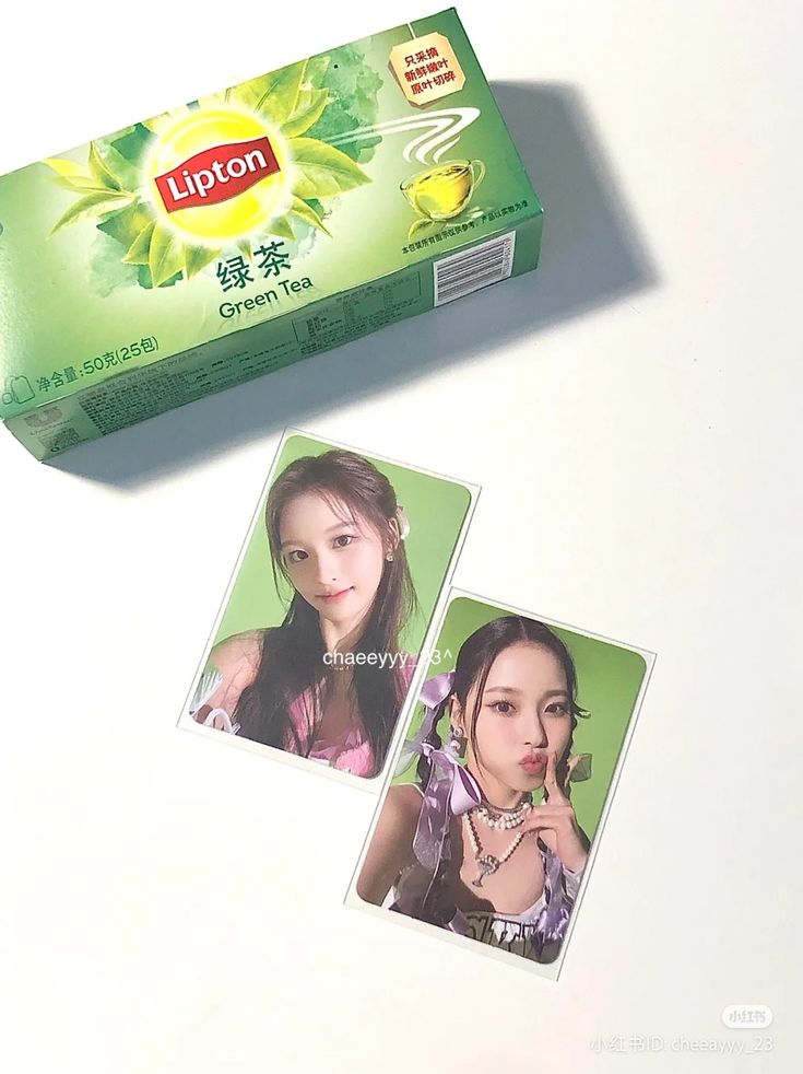 a box of lipton tea sitting on top of a white table next to two photos