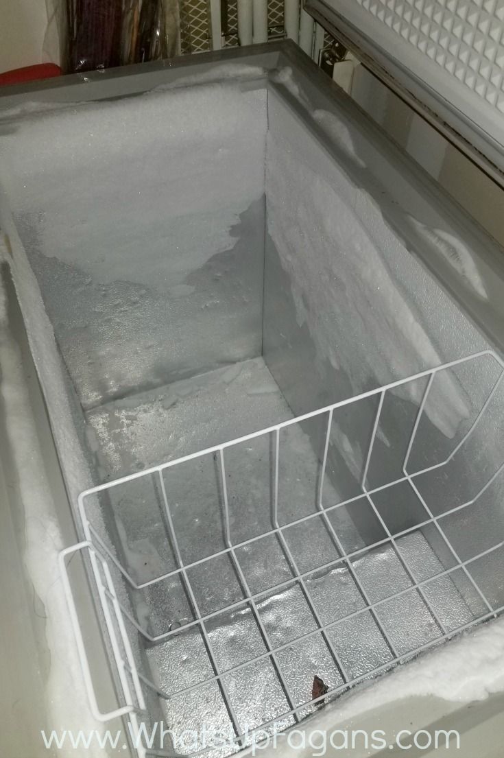 an empty dishwasher in the process of being cleaned