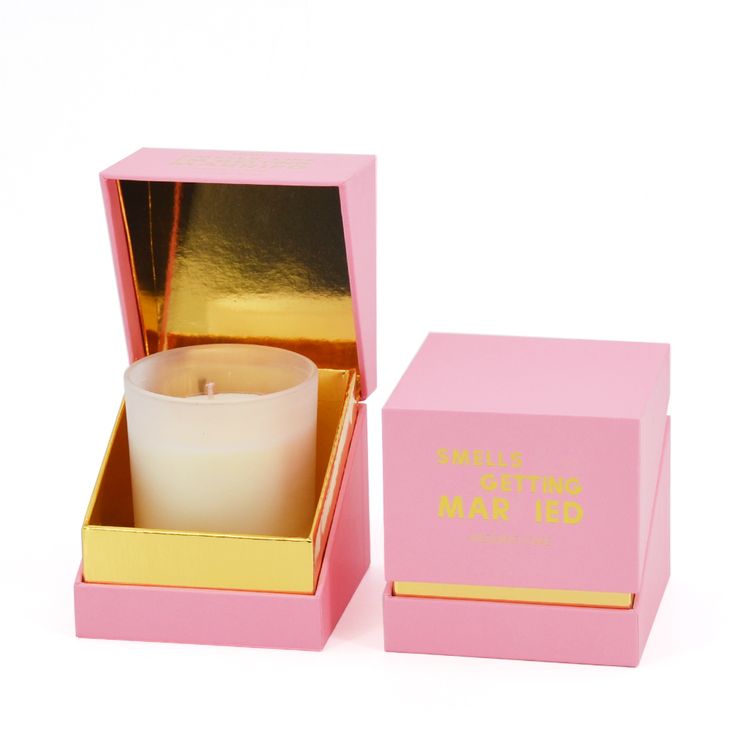 a pink box with a white candle inside