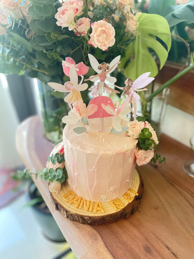 there is a cake with flowers on the table