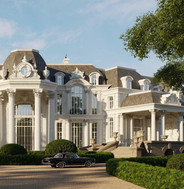 a black car parked in front of a large white mansion