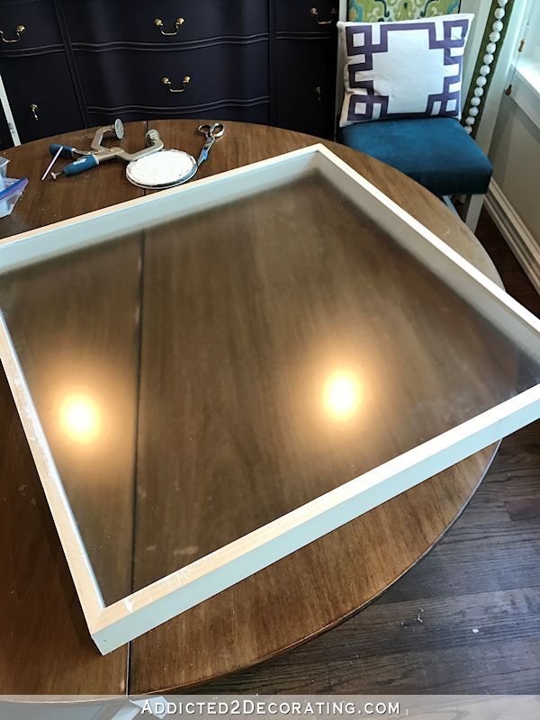 a wooden table topped with a large mirror