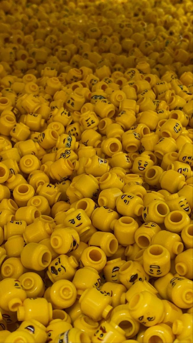 many yellow vases are stacked on top of each other