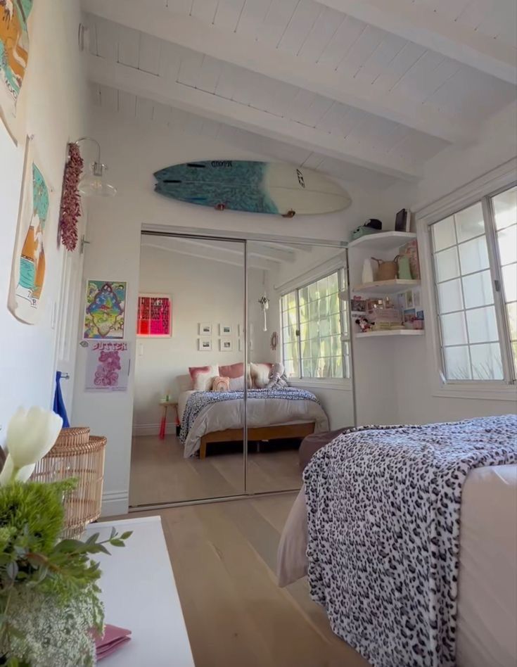 a bedroom with a surfboard hanging from the ceiling and a bed in the corner