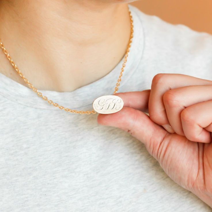 This one-of-a-kind necklace is composed of: Gold filled, Victorian watch fob charm from the late 1800s with hand engraved initials "GFK" on the bottom of the charm. This piece was originally made and sourced in England. This necklace measures a standard 16” on a modern 14k gold filled chain. The fob measures 1” in length and .75" in width. Brass Oval Pendant Necklace With Charms, Oval Pendant Necklace With Charms In Brass, Oval Pendant Brass Necklace With Charms, Classic Medallion Necklaces With Charms, Oval Pendant Charms Jewelry In Brass, Brass Oval Pendant Jewelry With Charms, Classic Oval Link Personalized Necklace, Classic Oval Pendant Personalized Necklace, Engraved Oval Pendant Jewelry For Everyday