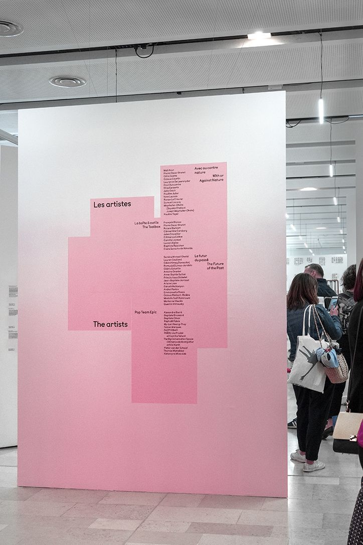 people are standing in front of a pink wall with words on it that read, the internet