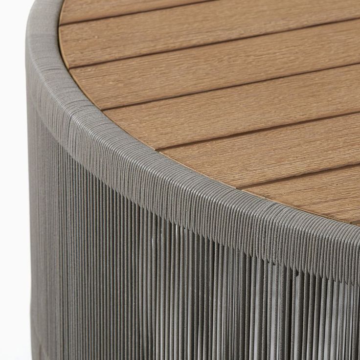 a close up view of a wooden bench with metal slats on it's sides