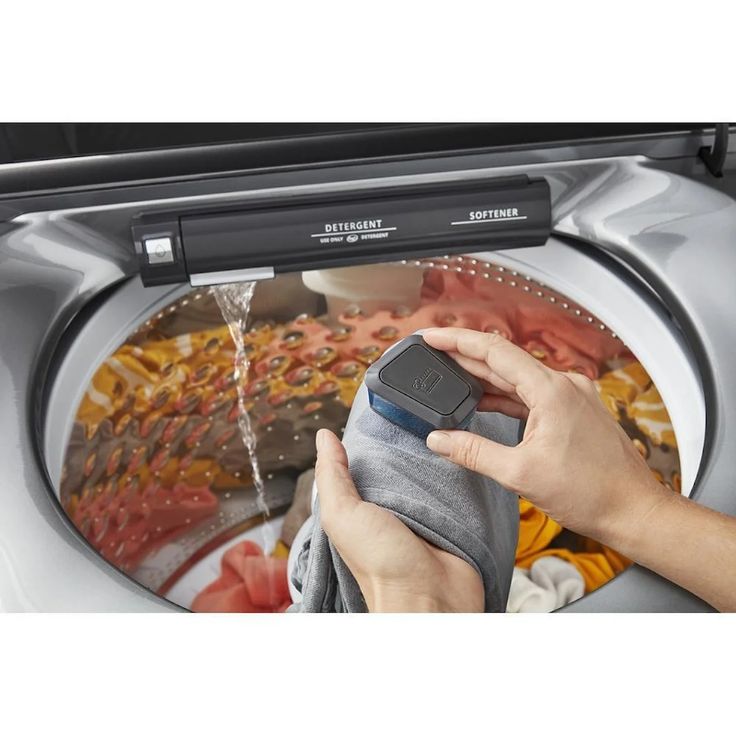 a person is cleaning the inside of an oven with a cloth in their hand and water coming out of it