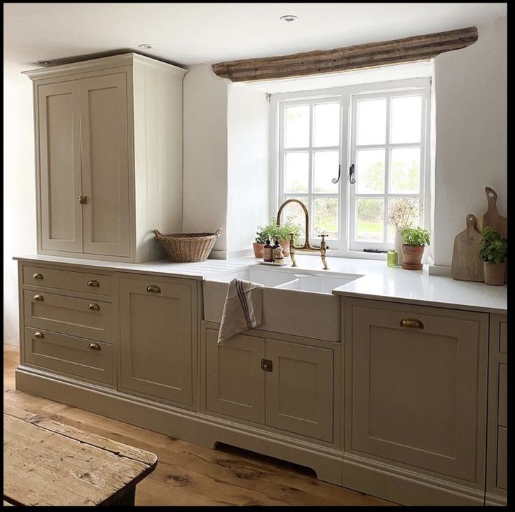 a kitchen with an oven, sink and window in the middle of it's room