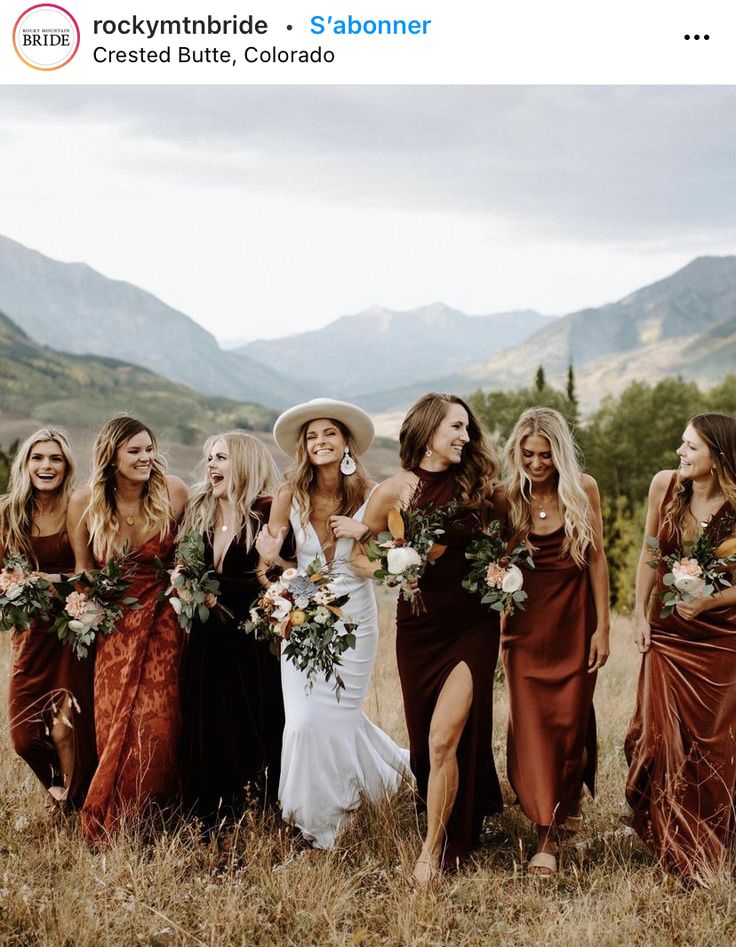 a group of women standing next to each other on top of a grass covered field