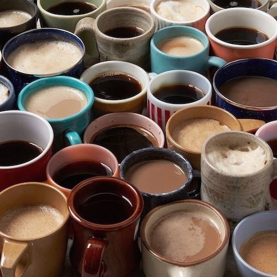 there are many different cups of coffee on the table, and one is full of them