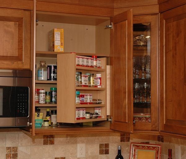 a kitchen with wooden cabinets and stainless steel microwave